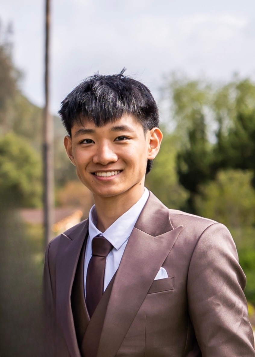 Sky Cheng smiling in a suit